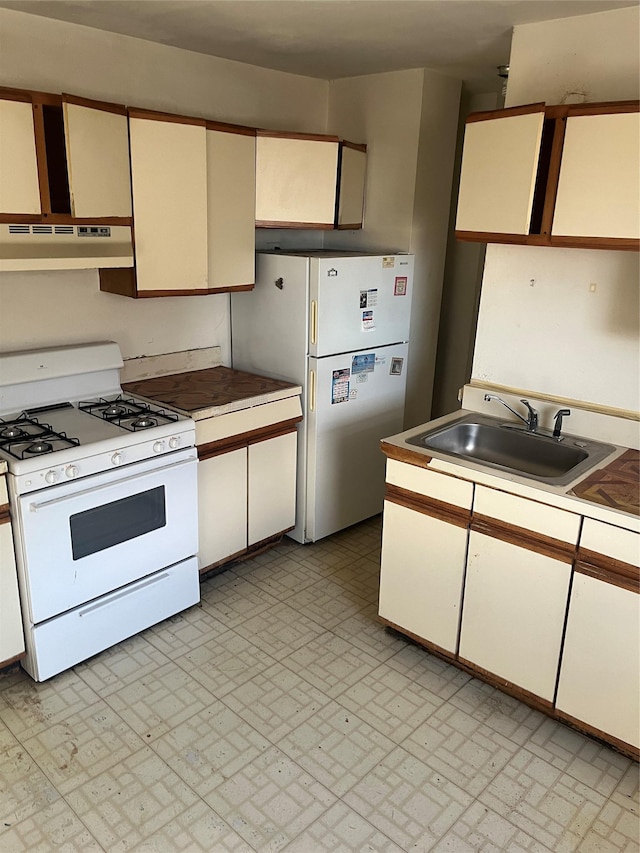 kitchen with exhaust hood, white appliances, and sink