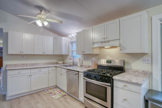 kitchen featuring white cabinetry, stainless steel appliances, and vaulted ceiling