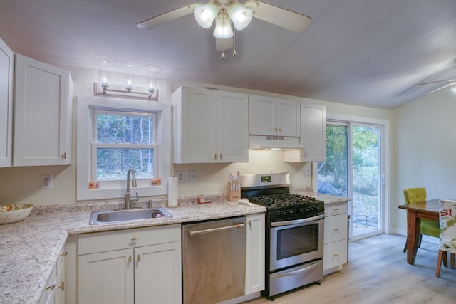 kitchen with white cabinetry, sink, ceiling fan, light hardwood / wood-style flooring, and appliances with stainless steel finishes