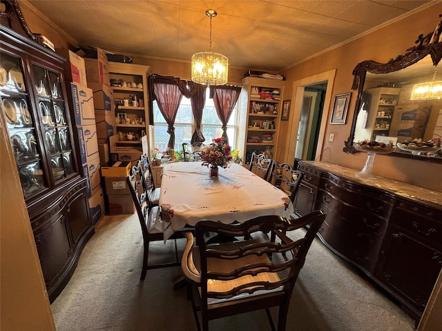 carpeted dining space featuring ornamental molding and a chandelier