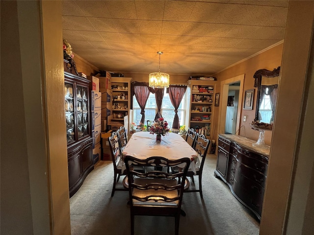 carpeted dining room with an inviting chandelier and crown molding