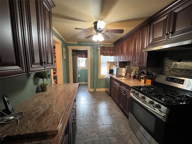 kitchen with decorative backsplash, sink, dark brown cabinets, and stainless steel appliances