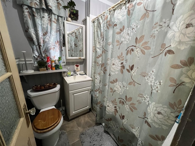 bathroom with tile patterned flooring, vanity, and toilet