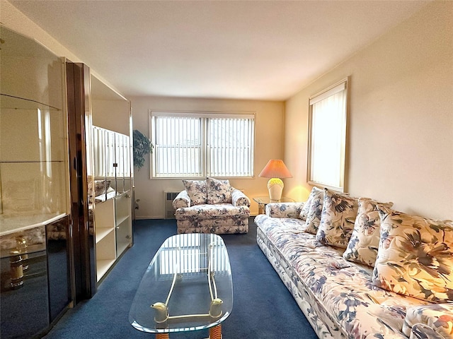 living room featuring plenty of natural light, dark carpet, and radiator heating unit