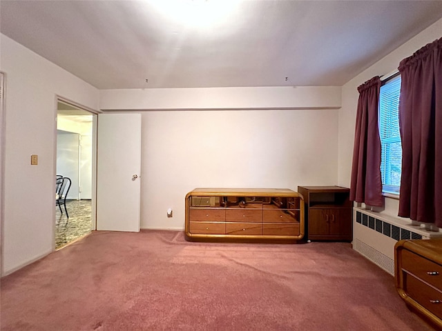 carpeted bedroom featuring radiator heating unit