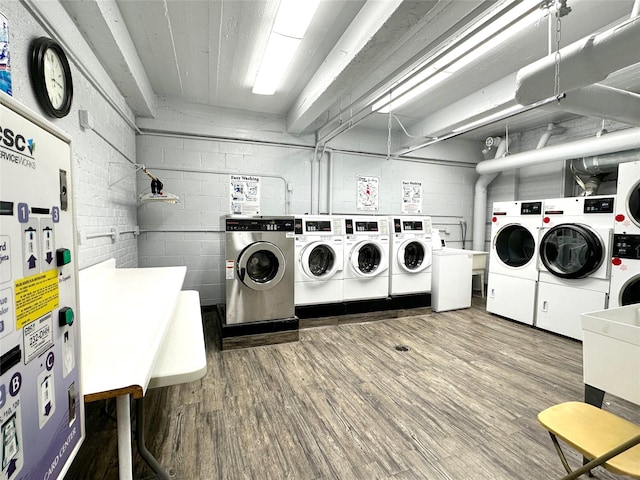 laundry area featuring independent washer and dryer and hardwood / wood-style flooring