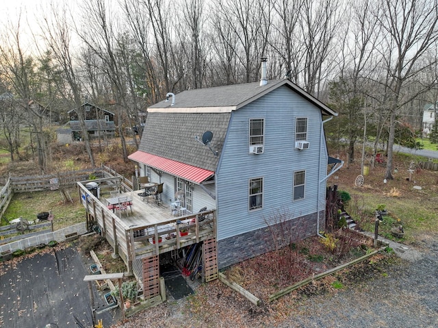 view of side of property with cooling unit and a wooden deck