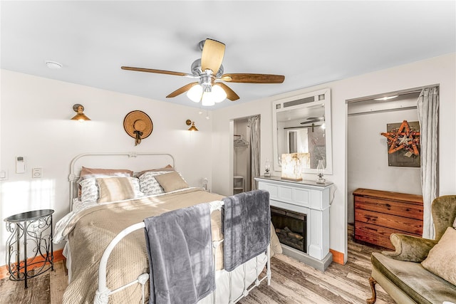 bedroom with a closet, ceiling fan, and light hardwood / wood-style flooring