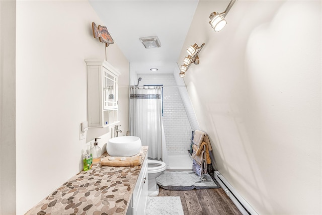 bathroom with curtained shower, sink, a baseboard radiator, wood-type flooring, and toilet