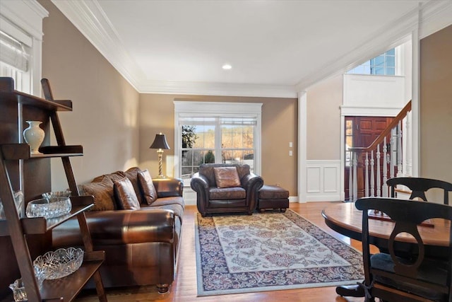 living room featuring hardwood / wood-style floors and crown molding