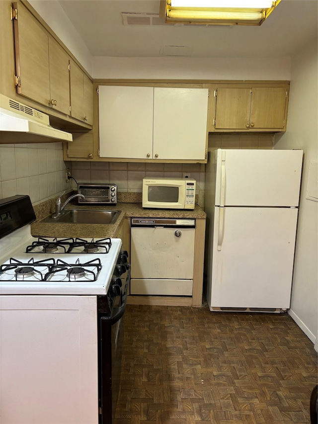 kitchen featuring dark parquet floors, decorative backsplash, white appliances, and sink