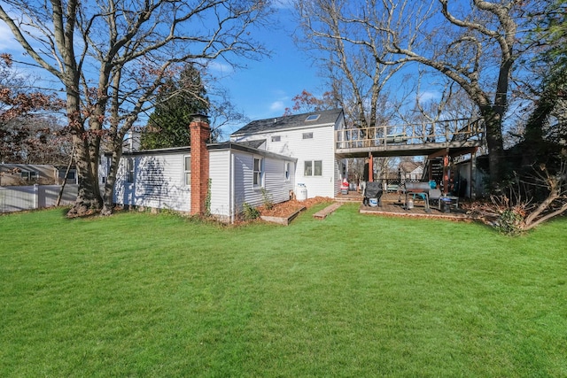 rear view of house with a lawn and a patio area