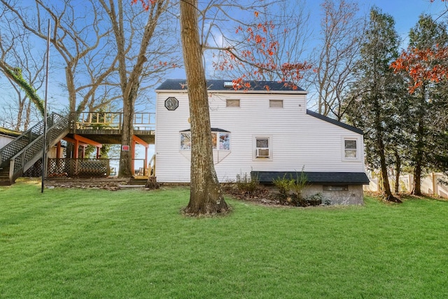 back of property featuring a deck and a yard