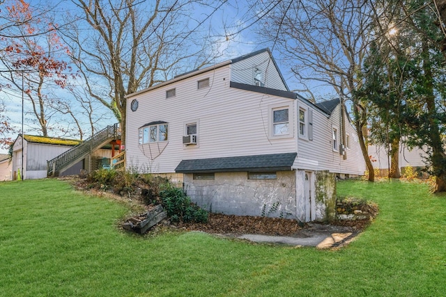 rear view of property featuring cooling unit and a yard