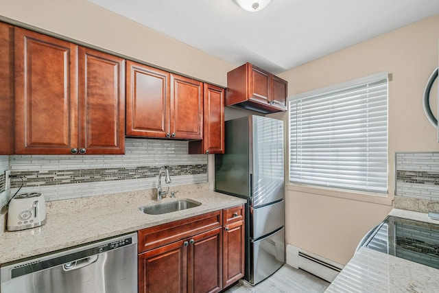 kitchen featuring light stone countertops, appliances with stainless steel finishes, baseboard heating, and sink