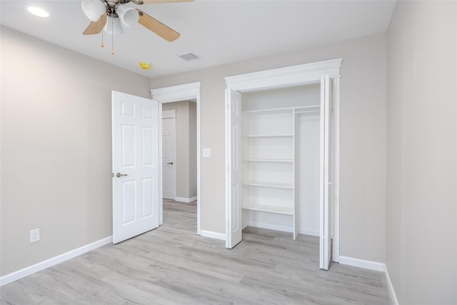 unfurnished bedroom featuring a closet, light hardwood / wood-style flooring, and ceiling fan