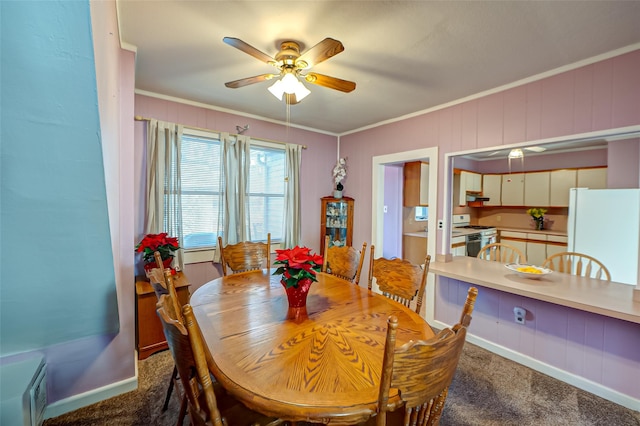 dining space featuring ceiling fan, crown molding, and carpet floors