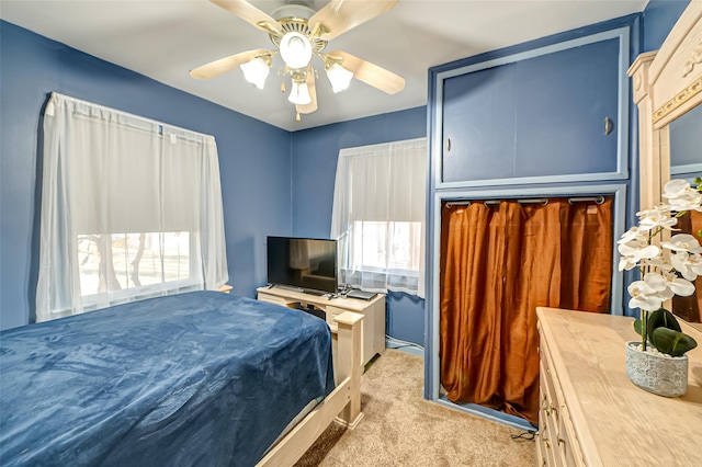 carpeted bedroom with ceiling fan