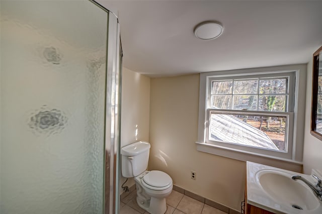 bathroom featuring toilet, tile patterned flooring, vanity, and walk in shower