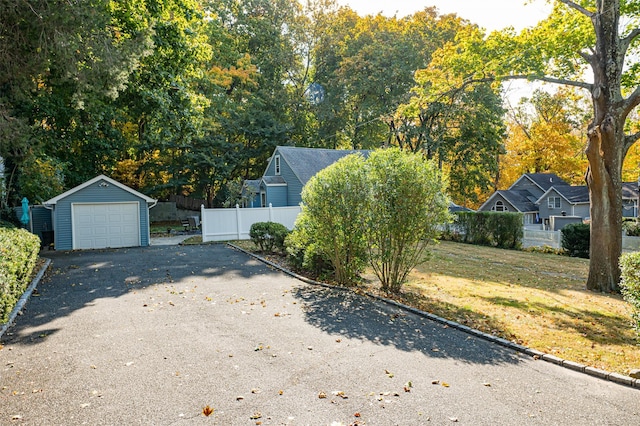 exterior space featuring a yard, an outdoor structure, and a garage