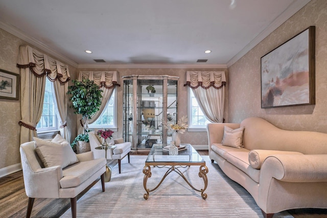 living area featuring hardwood / wood-style floors and crown molding