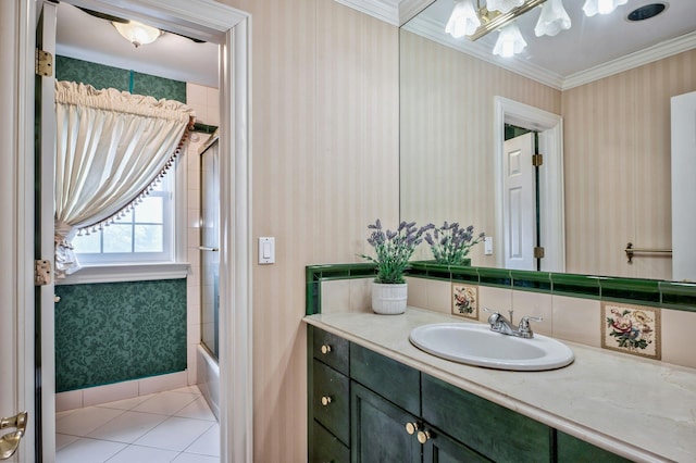 bathroom featuring tile patterned floors, vanity, shower / bath combination with glass door, and ornamental molding