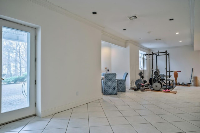 exercise area featuring light tile patterned floors and ornamental molding