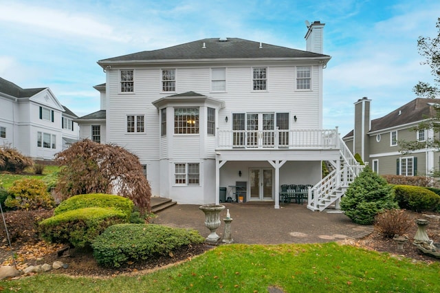 rear view of house featuring french doors, a deck, and a patio area