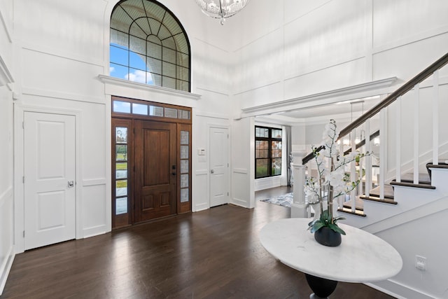 foyer entrance featuring a high ceiling and dark hardwood / wood-style flooring