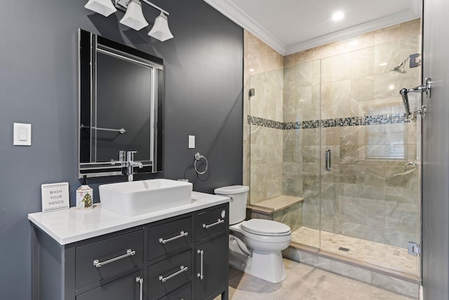 bathroom featuring tile patterned floors, toilet, crown molding, vanity, and a shower with door