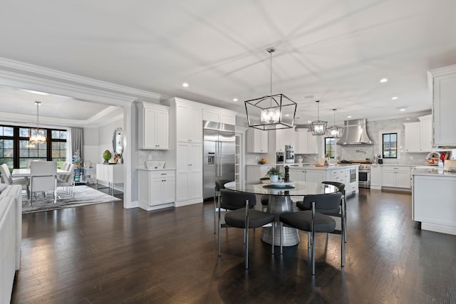 dining area with crown molding, dark hardwood / wood-style flooring, and a chandelier