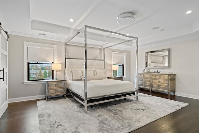 bedroom featuring dark hardwood / wood-style flooring, a tray ceiling, ornamental molding, and a barn door