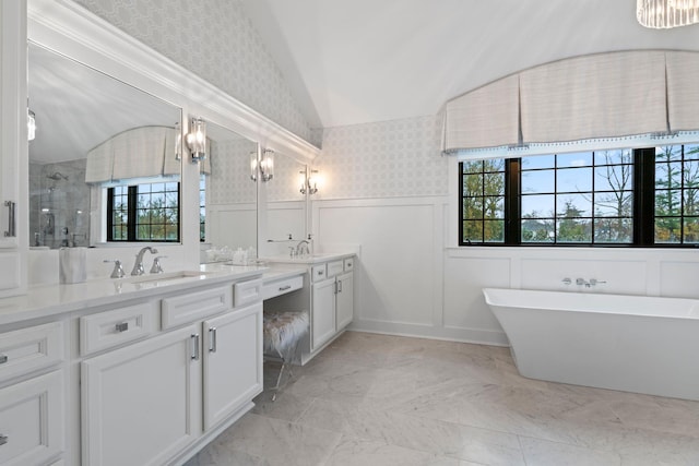 bathroom with vanity, vaulted ceiling, plus walk in shower, and a healthy amount of sunlight