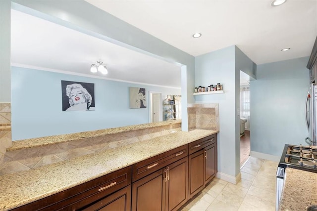 2 Soundview Ave Unit 2D, White Plains, NY 10606 - kitchen featuring appliances with stainless steel finishes, light stone countertops, decorative backsplash, and recessed lighting