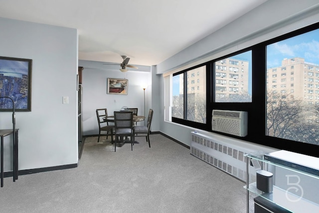 carpeted dining room with radiator, cooling unit, and ceiling fan