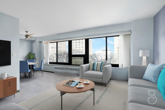 living room with radiator, plenty of natural light, light colored carpet, and ceiling fan