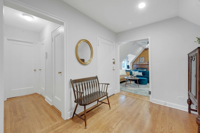 interior space with ceiling fan, light hardwood / wood-style floors, and lofted ceiling