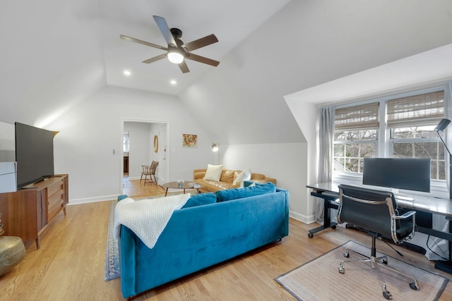 living room featuring ceiling fan, light hardwood / wood-style floors, and lofted ceiling