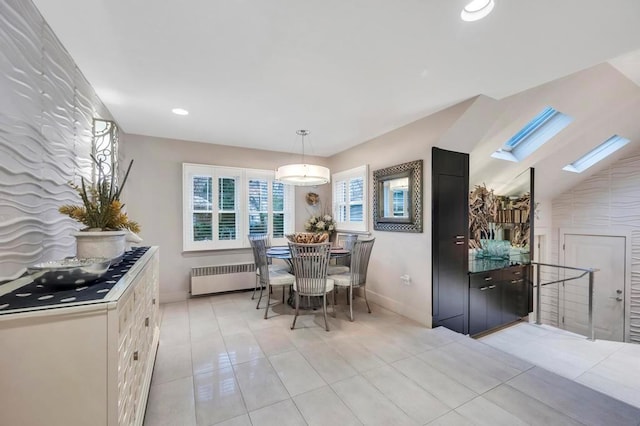 tiled dining space featuring radiator and a skylight