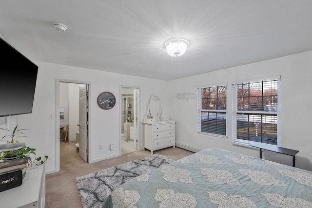 carpeted bedroom with ensuite bathroom and baseboard heating