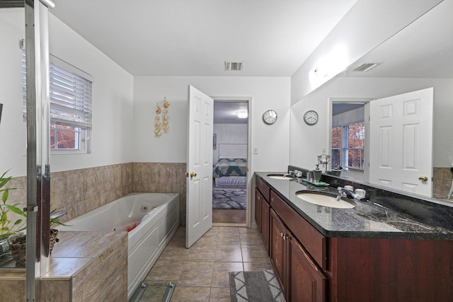 bathroom featuring vanity, tile patterned floors, and a bathtub