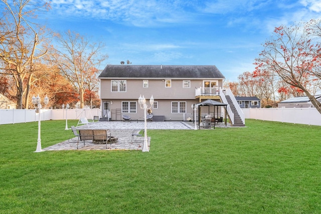 back of house with a lawn and a patio