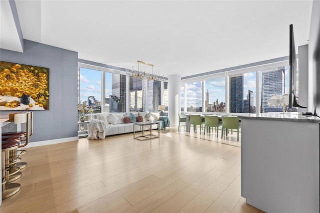 living room with a wealth of natural light and light hardwood / wood-style flooring