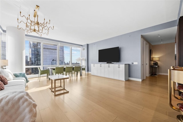 living room with light hardwood / wood-style flooring and a chandelier