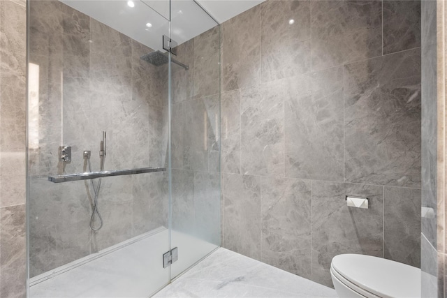 bathroom featuring walk in shower, tile walls, and toilet