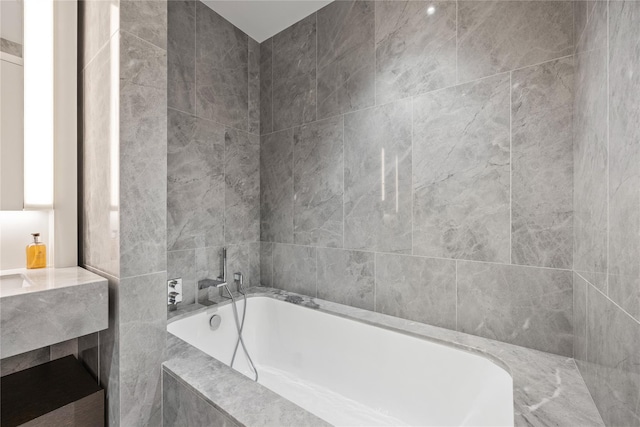 bathroom featuring tiled bath