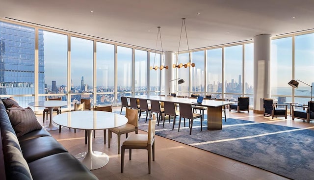 dining space with expansive windows and hardwood / wood-style flooring