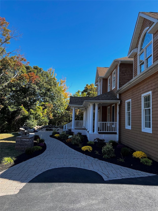 view of side of property with a porch