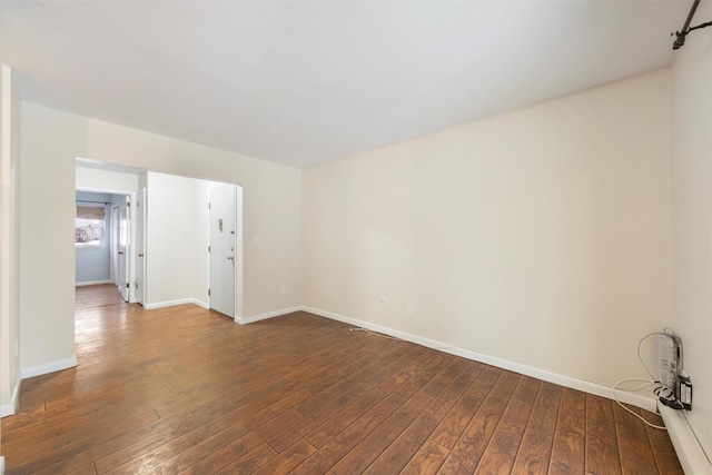 spare room featuring dark wood-type flooring