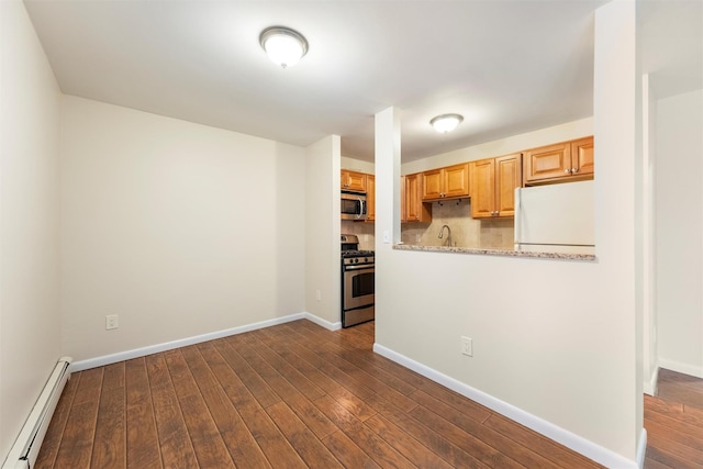 kitchen featuring backsplash, baseboard heating, stainless steel appliances, and dark wood-type flooring